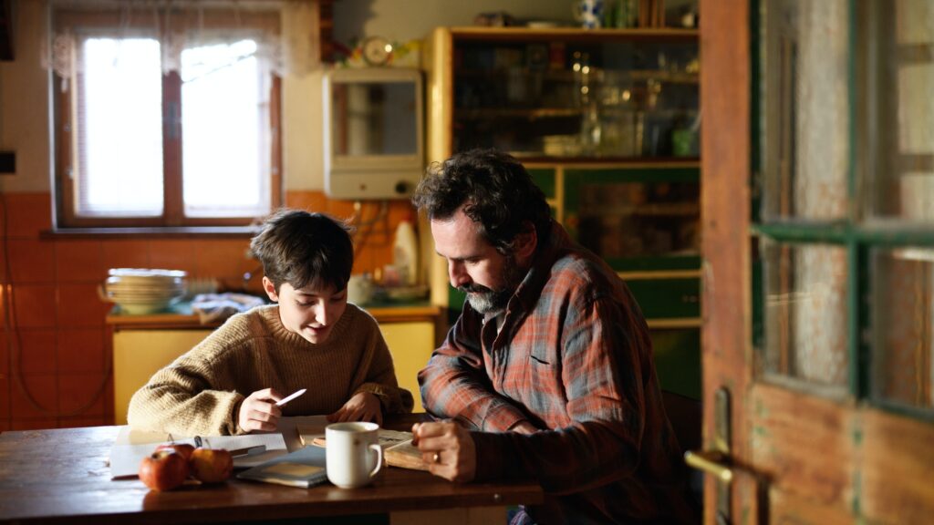 Poor mature father and small daughter learning indoors at home, poverty concept