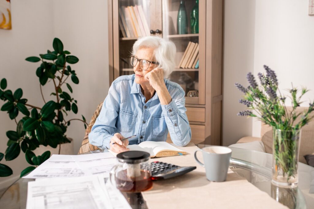 Pensive Senior Woman Counting Taxes