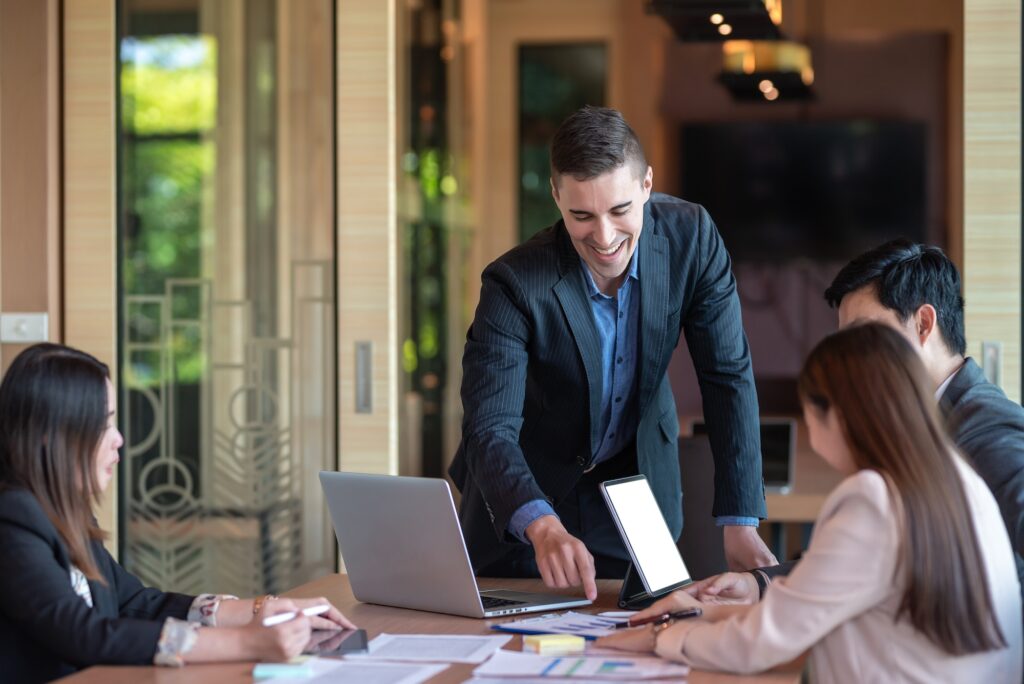 Group of business people investment advisors analyzing financial report in meeting.