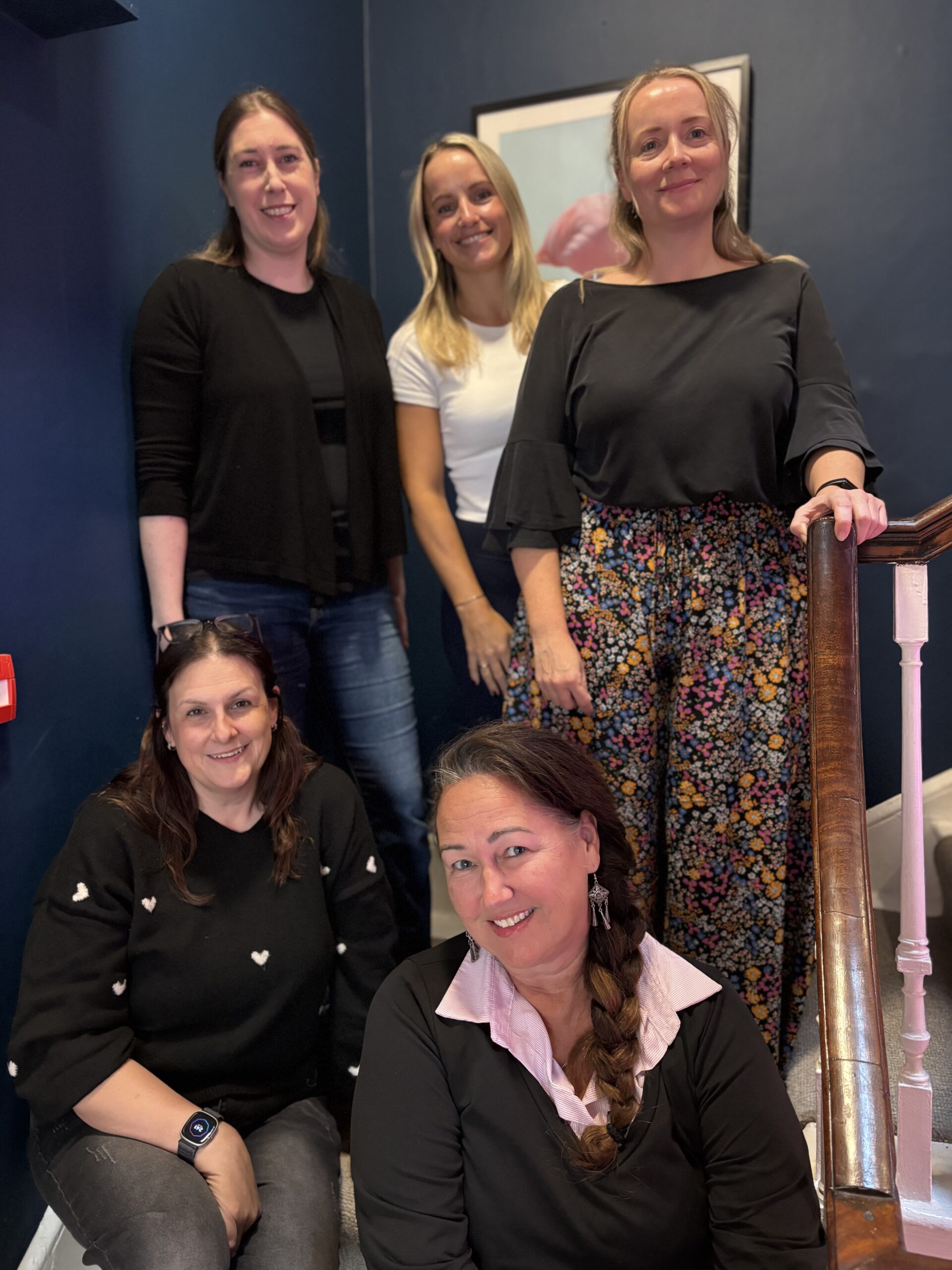 A photo of the Pengage team - Laura, Helen, Rachel, Charlotte and Gilly, on a staircase, all are smiling